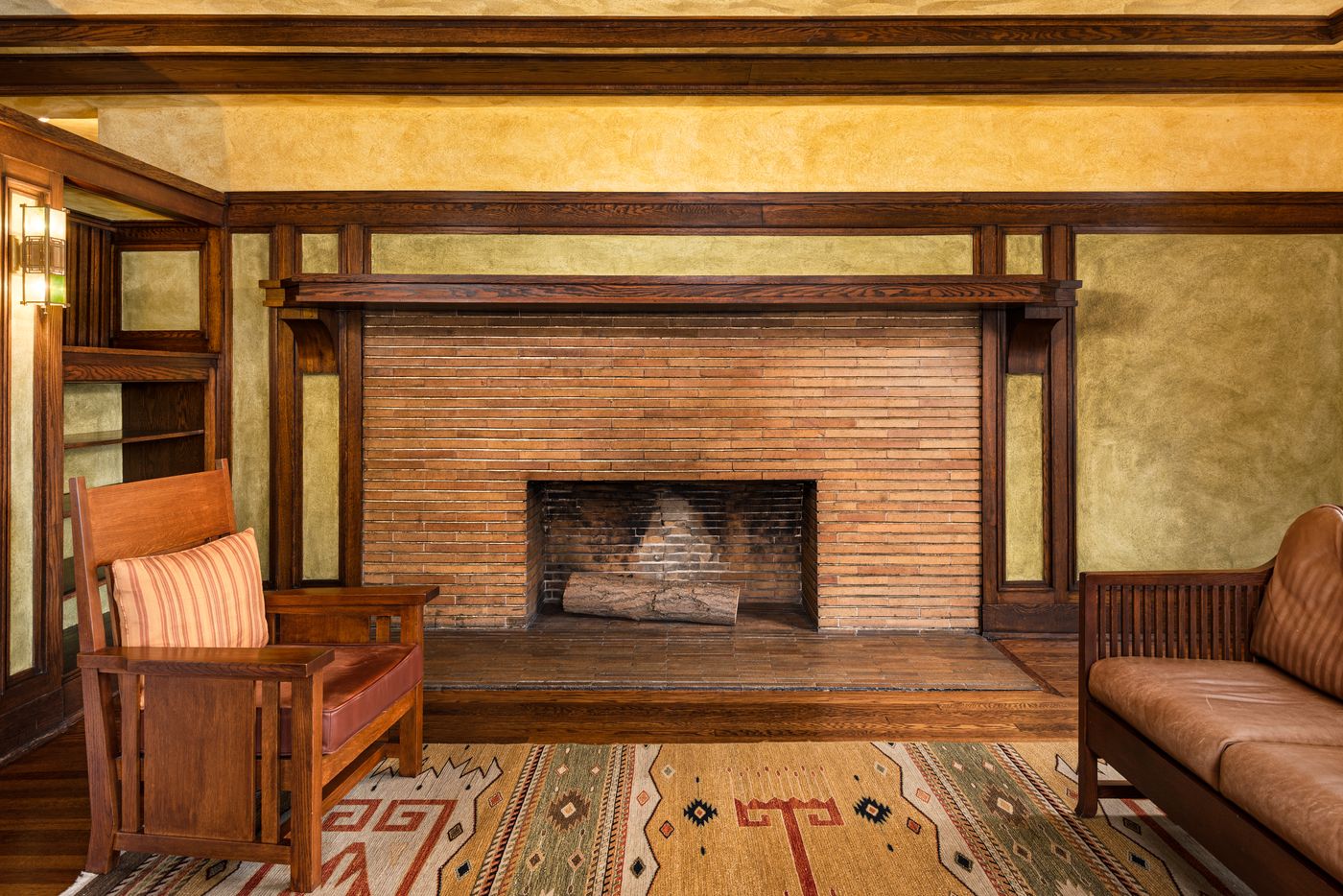 Original woodwork and craftsman fireplace inside a restored Frank Lloyd Wright Buffalo home
