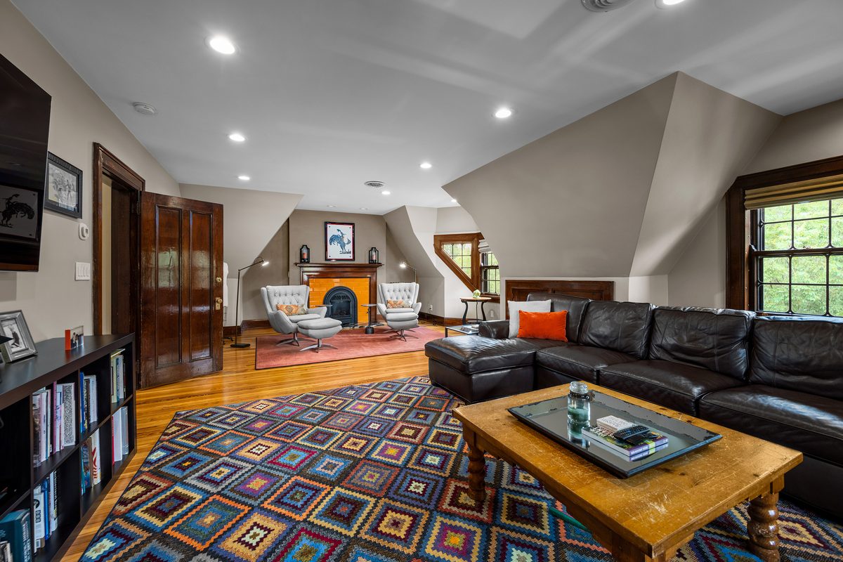 Rental photography, den with sectional and fireplace